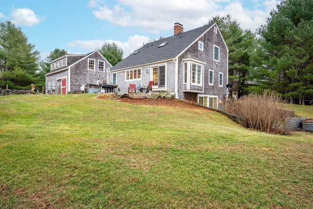 back of property featuring a lawn