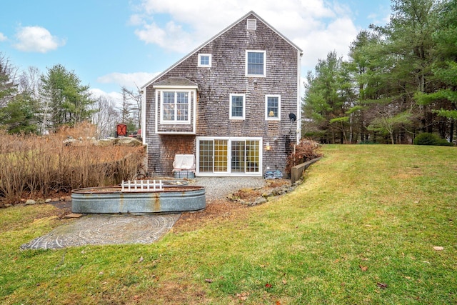 back of house with a lawn