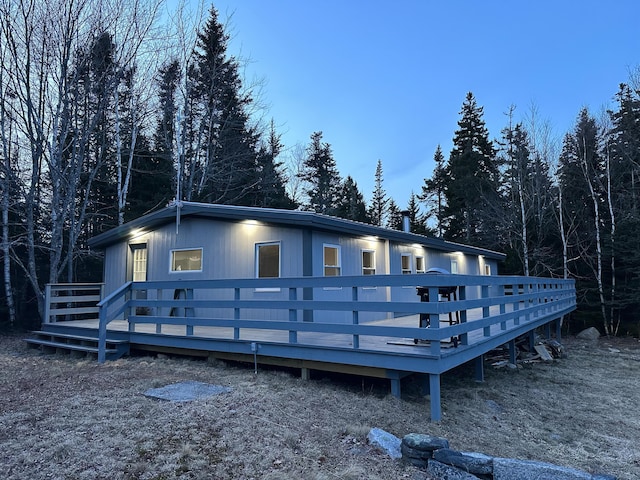 rear view of house featuring a wooden deck