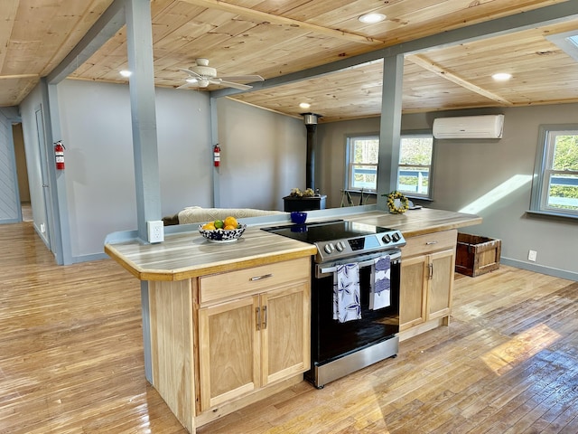 kitchen with a wall mounted air conditioner, stainless steel range with electric cooktop, light brown cabinets, wooden ceiling, and light hardwood / wood-style flooring