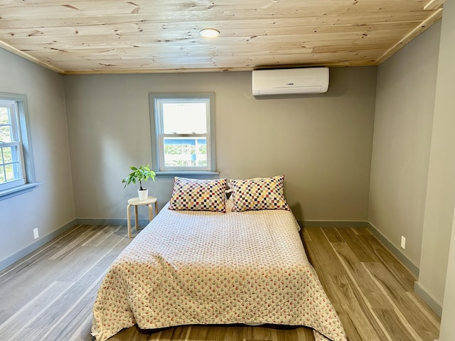 bedroom featuring an AC wall unit, wooden ceiling, and light hardwood / wood-style flooring