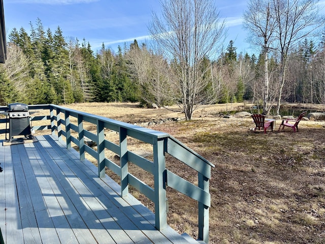 wooden deck featuring a grill