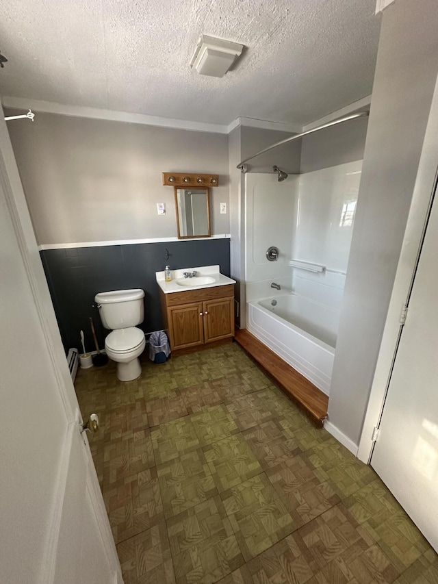 full bathroom with toilet, shower / tub combination, a textured ceiling, and vanity