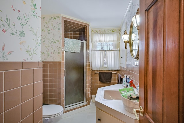 bathroom with tile walls, tile patterned flooring, vanity, a shower with shower door, and toilet