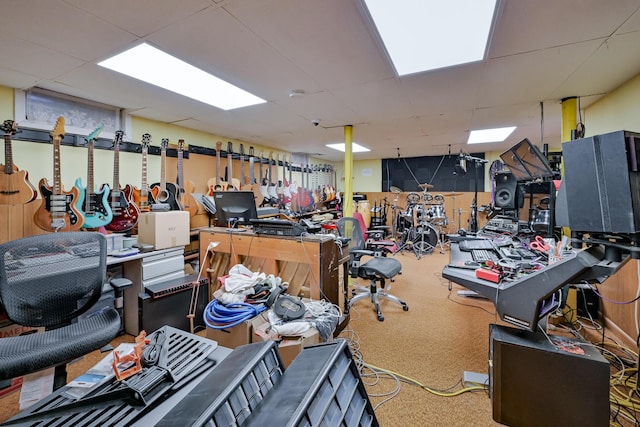 miscellaneous room featuring a paneled ceiling and a workshop area