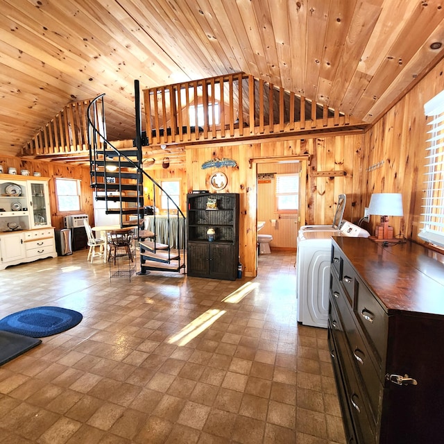 interior space featuring dark brown cabinetry, washer / clothes dryer, wooden walls, and wooden ceiling