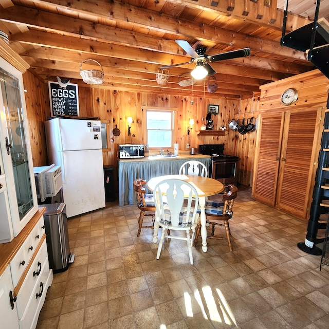 dining room featuring sink, wood ceiling, ceiling fan, beam ceiling, and wooden walls