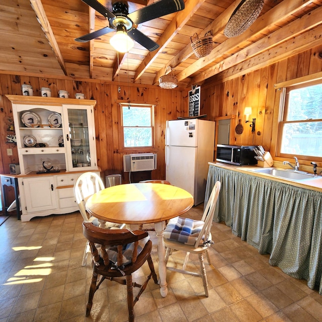 dining space featuring a wall mounted air conditioner, wood ceiling, plenty of natural light, and sink