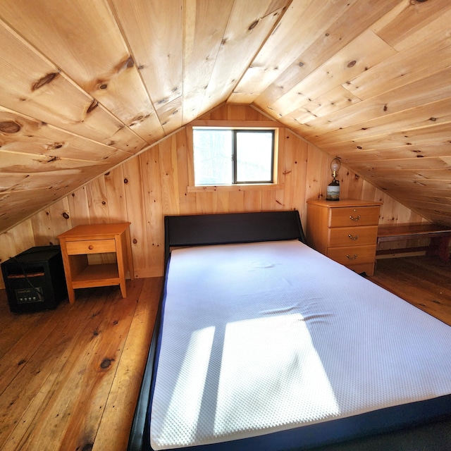 bedroom with lofted ceiling, hardwood / wood-style floors, wood ceiling, and wood walls