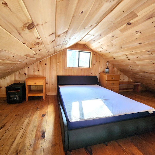 unfurnished bedroom featuring hardwood / wood-style floors, wooden ceiling, and wood walls