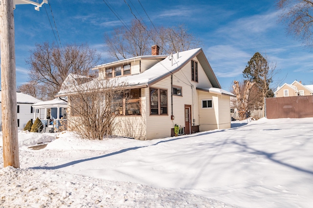 view of snow covered rear of property