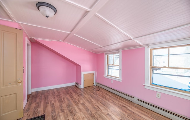 bonus room with baseboard heating and wood-type flooring