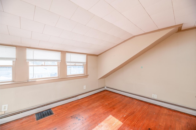 empty room with lofted ceiling and hardwood / wood-style floors