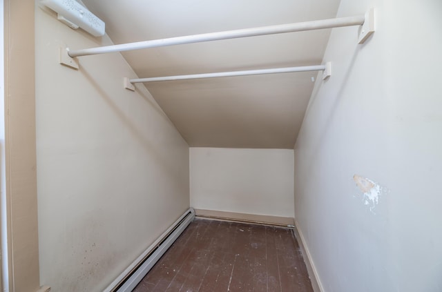 walk in closet featuring a baseboard heating unit and dark wood-type flooring