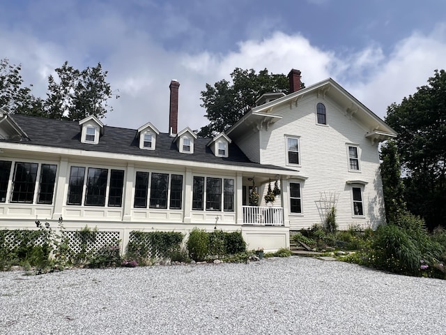 back of house featuring a porch