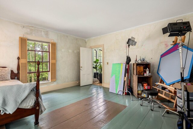 bedroom featuring ornamental molding and dark wood-type flooring
