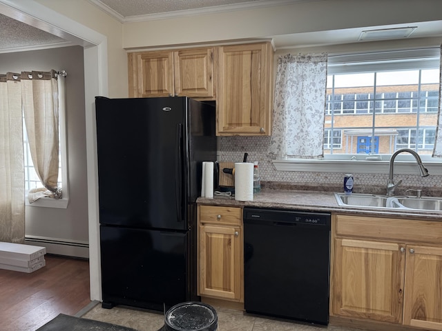 kitchen featuring crown molding, baseboard heating, light wood-style flooring, black appliances, and a sink