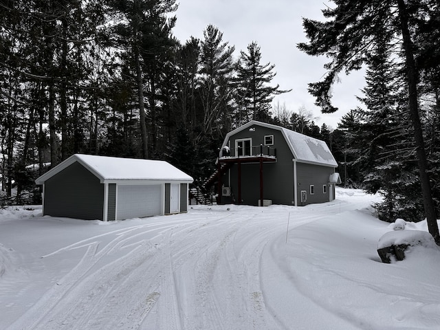 snow covered structure featuring a garage