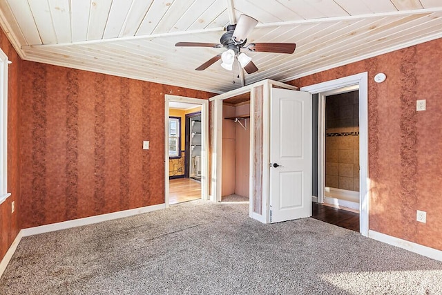 unfurnished bedroom with ceiling fan, carpet flooring, wood ceiling, and a closet