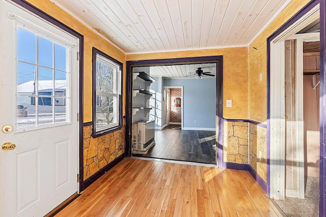 entryway with ornamental molding, hardwood / wood-style floors, and wood ceiling