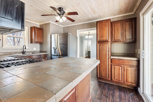 kitchen featuring dark hardwood / wood-style floors, tile countertops, ornamental molding, wood ceiling, and stainless steel fridge with ice dispenser