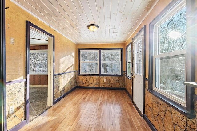 unfurnished sunroom featuring wood ceiling