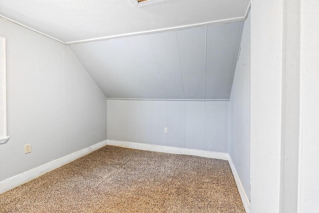 bonus room with lofted ceiling and carpet