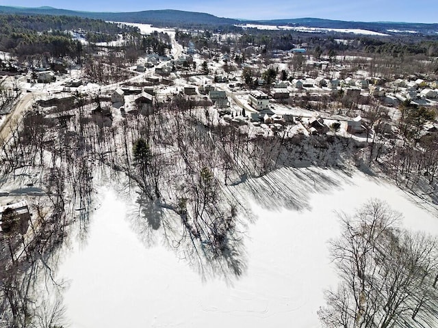 snowy aerial view with a mountain view