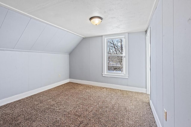 additional living space with lofted ceiling and carpet floors