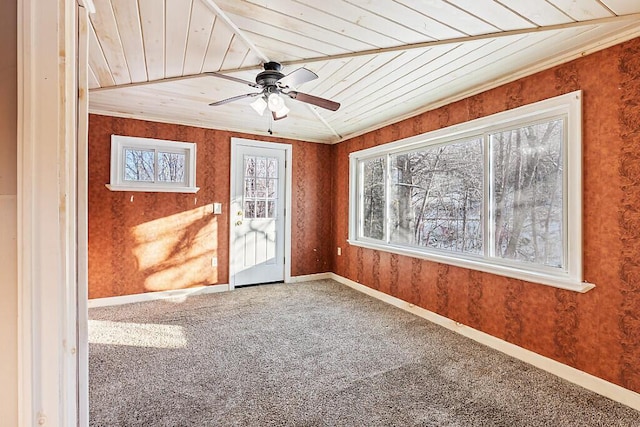 unfurnished sunroom featuring wood ceiling and ceiling fan