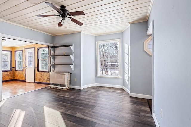 spare room with dark hardwood / wood-style flooring, ceiling fan, ornamental molding, and wooden ceiling