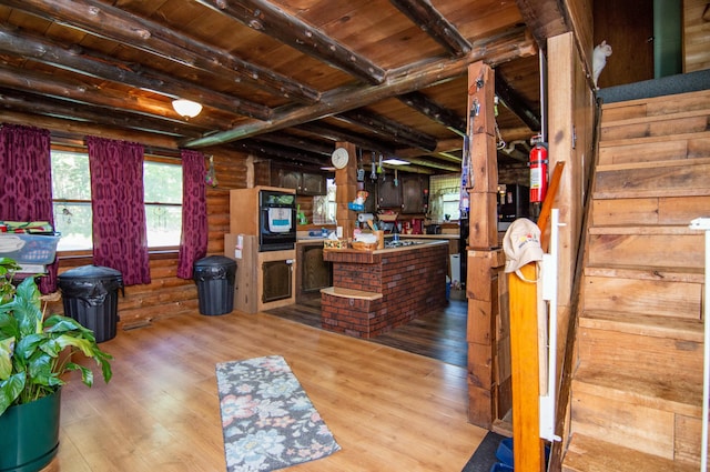 interior space featuring hardwood / wood-style flooring, rustic walls, wood ceiling, and beamed ceiling