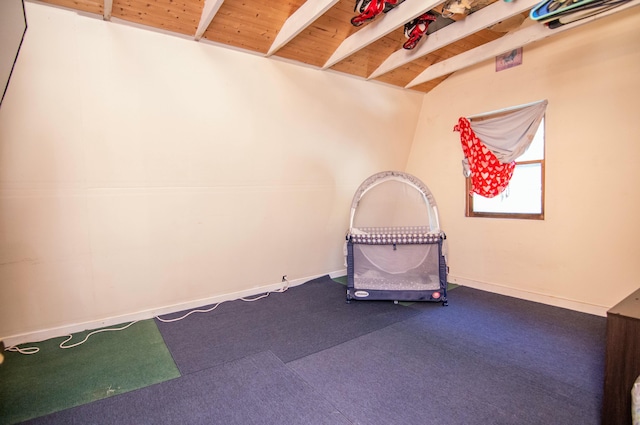 unfurnished room with lofted ceiling with beams and wood ceiling