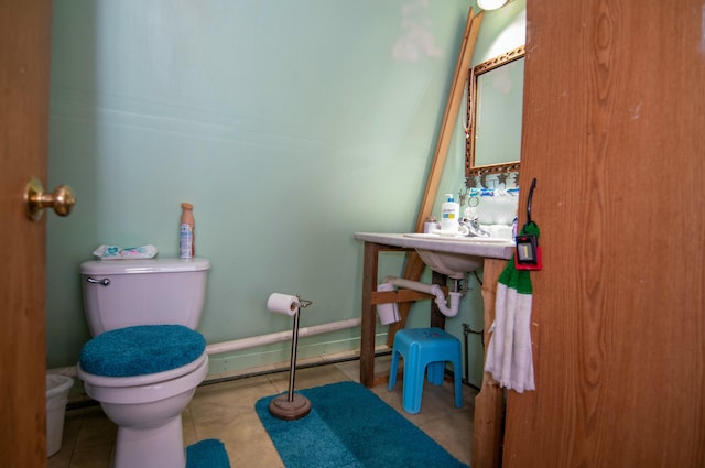 bathroom with sink, tile patterned floors, and toilet