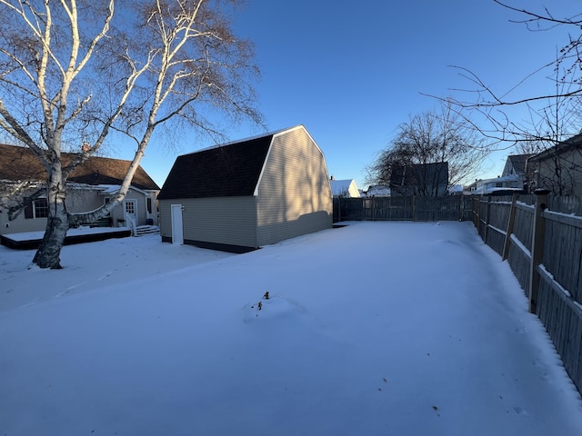 yard covered in snow featuring an outdoor structure