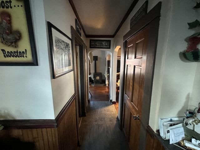 corridor with ornamental molding and dark hardwood / wood-style floors