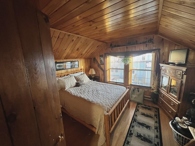 bedroom featuring lofted ceiling, hardwood / wood-style flooring, wooden ceiling, and wood walls