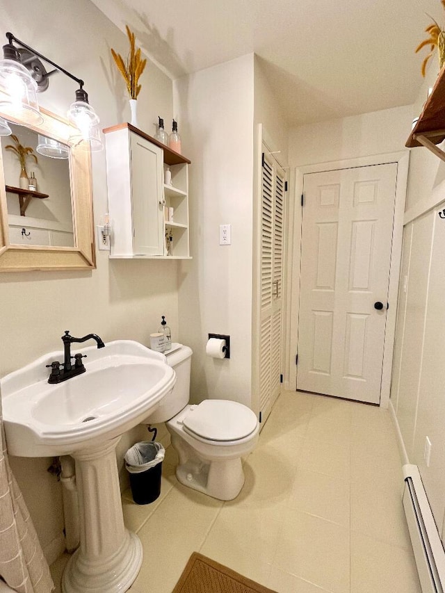 bathroom featuring a baseboard radiator and toilet