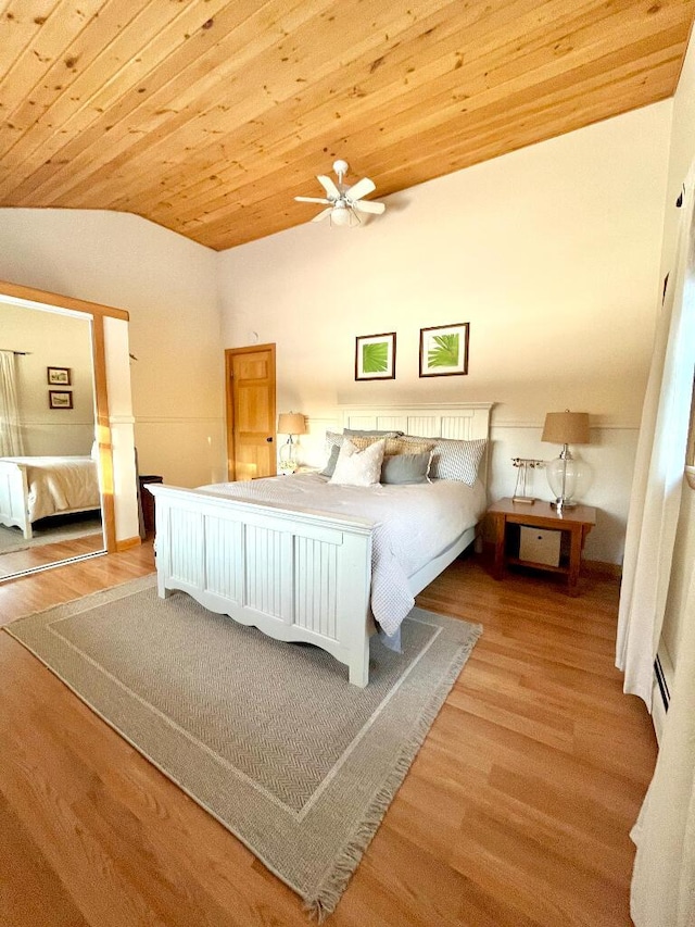 bedroom featuring ceiling fan, lofted ceiling, light hardwood / wood-style flooring, and wooden ceiling