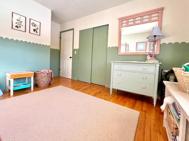 bedroom featuring light hardwood / wood-style floors and a closet