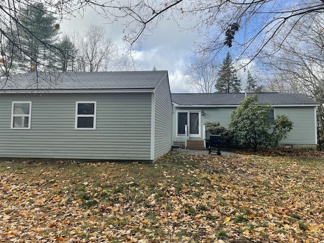 back of house with entry steps and a lawn