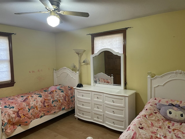 11 Partridge Dr, Gardiner, ME 04345 - bedroom featuring multiple windows, dark wood finished floors, and a ceiling fan