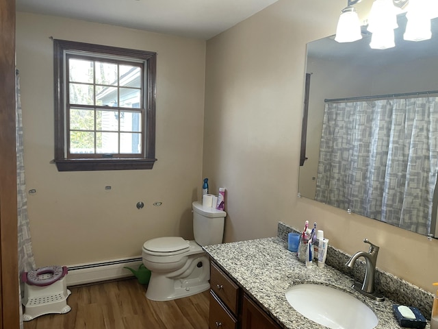 11 Partridge Dr, Gardiner, ME 04345 - full bath featuring toilet, baseboard heating, wood finished floors, and vanity
