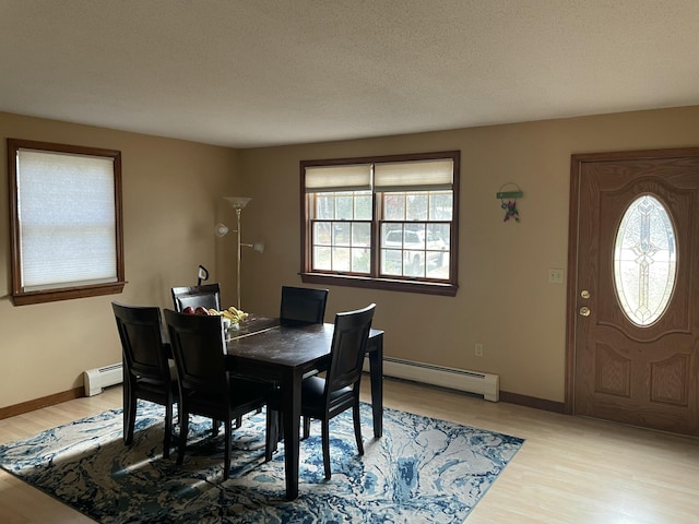 11 Partridge Dr, Gardiner, ME 04345 - dining space with a baseboard heating unit, baseboards, and light wood-style floors
