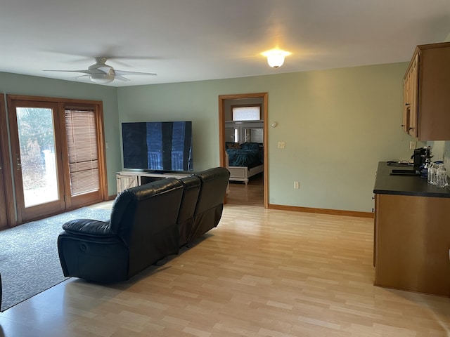 11 Partridge Dr, Gardiner, ME 04345 - living room featuring light wood finished floors, a ceiling fan, and baseboards