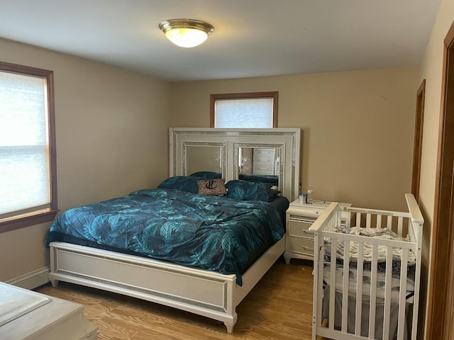 11 Partridge Dr, Gardiner, ME 04345 - bedroom with a baseboard radiator, wood finished floors, and baseboards