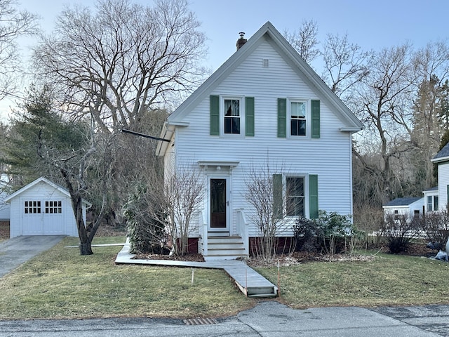 view of front facade with a garage, an outdoor structure, and a front lawn