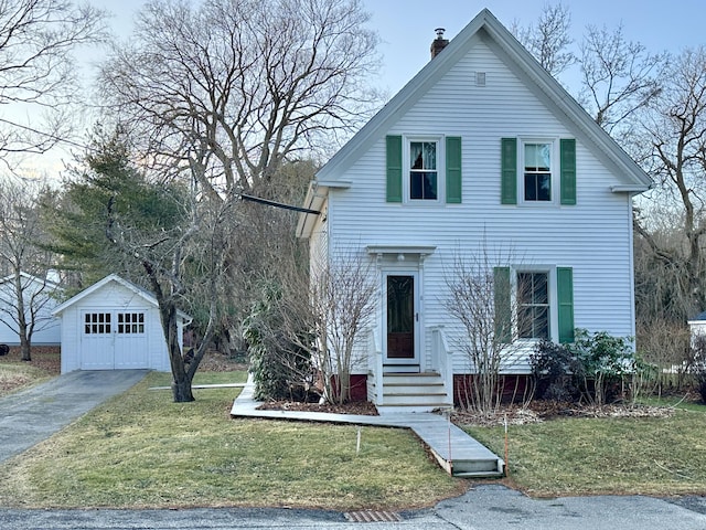 view of front of property with a garage, an outbuilding, and a front yard