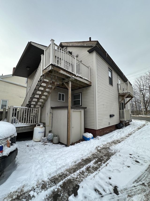 view of snow covered exterior with a deck