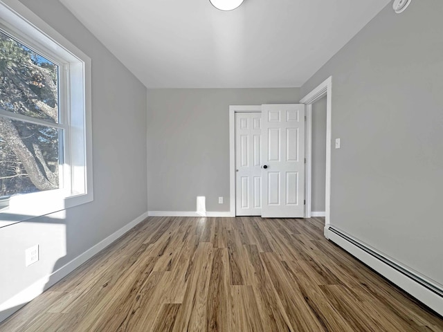 interior space featuring a baseboard radiator, a closet, and light hardwood / wood-style flooring